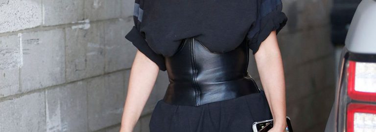 Mulher usando corset por cima da blusa