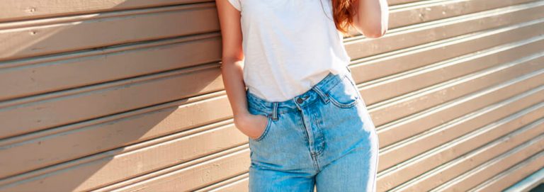 Mulher usando calça jeans de cintura alta e camiseta branca