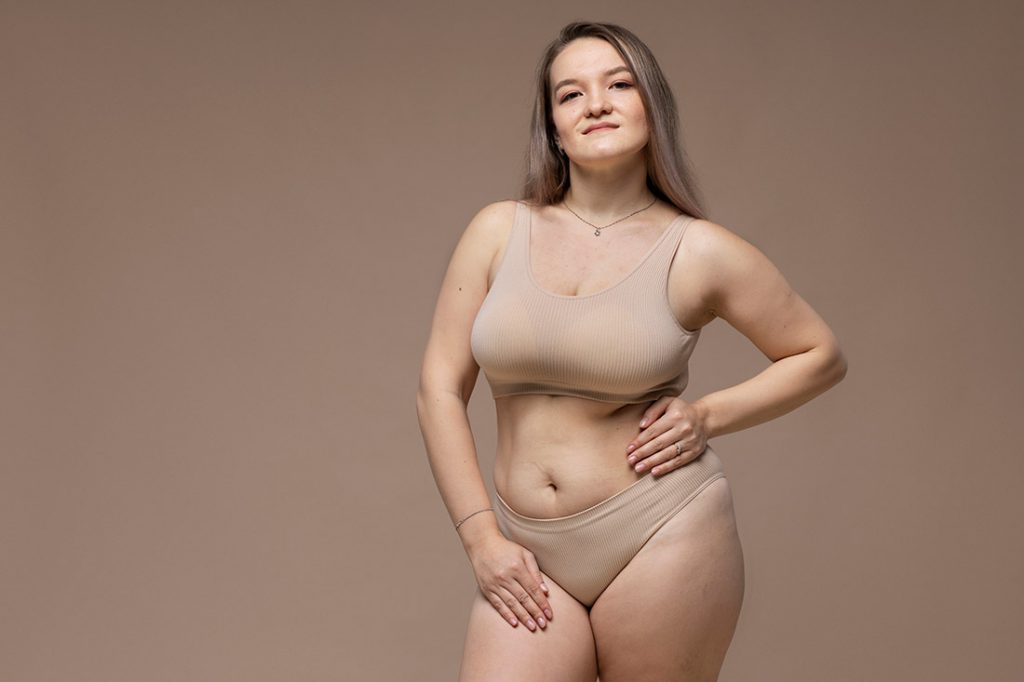 Mulher plus size de lingerie bege