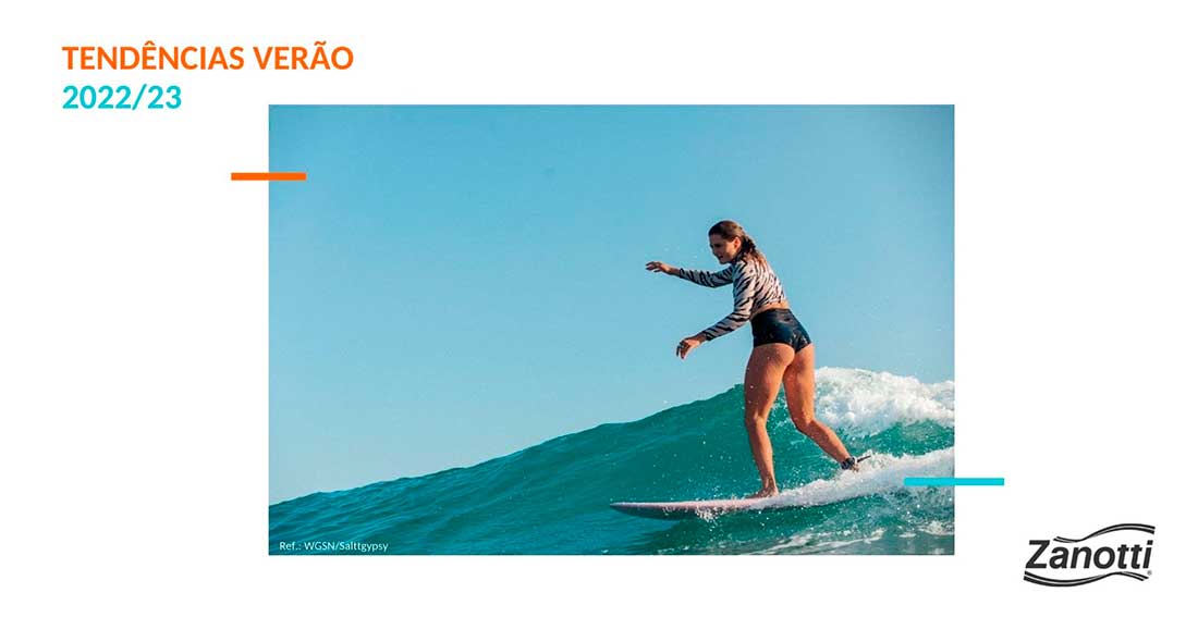 imagem de mulher surfando, usando peças de moda praia 2023, que trazem a tendência da estética esportiva